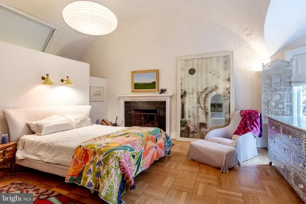 a bedroom with bed couch and window