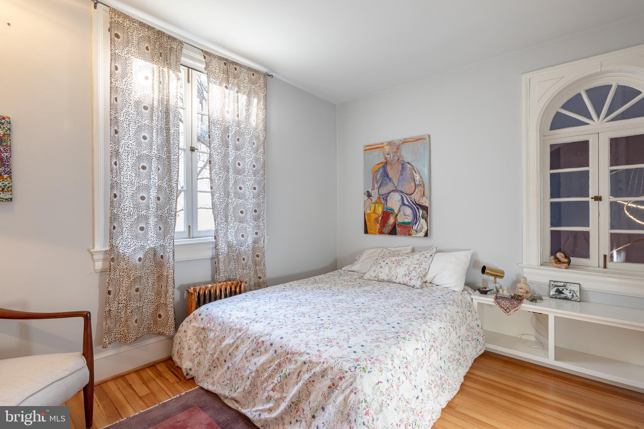 2633 15th Street Northwest, Unit 3 Washington, DC 20009 - Photo 30 of 53 a bedroom with a bed and a large window