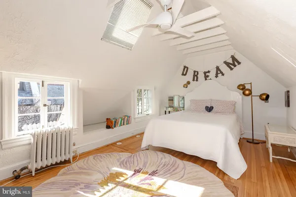 a bathroom with a sink a bathtub and next to a window
