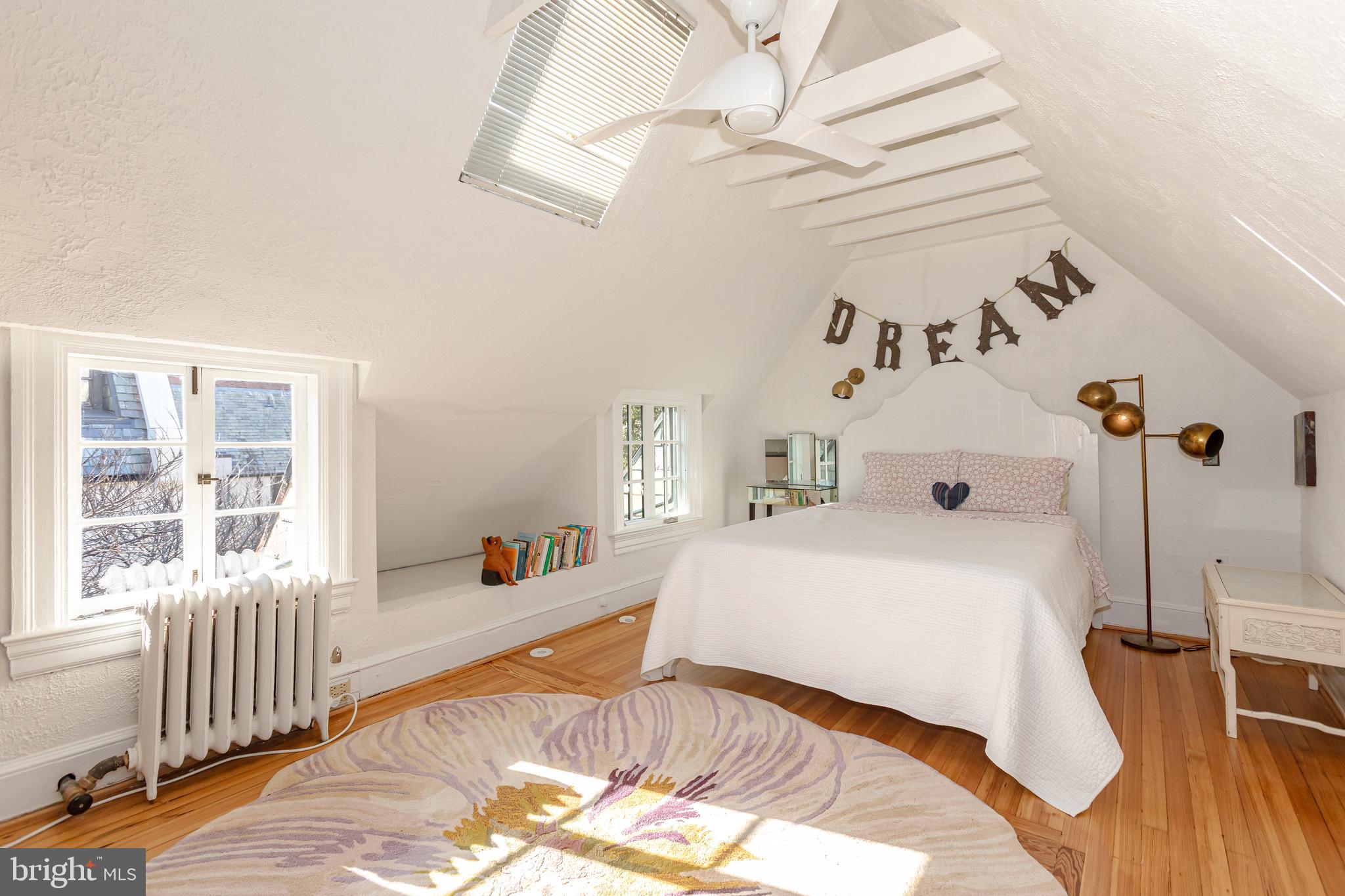 2633 15th Street Northwest, Unit 3 Washington, DC 20009 - Photo 42 of 53 a bedroom with a bed and a table with wooden floor