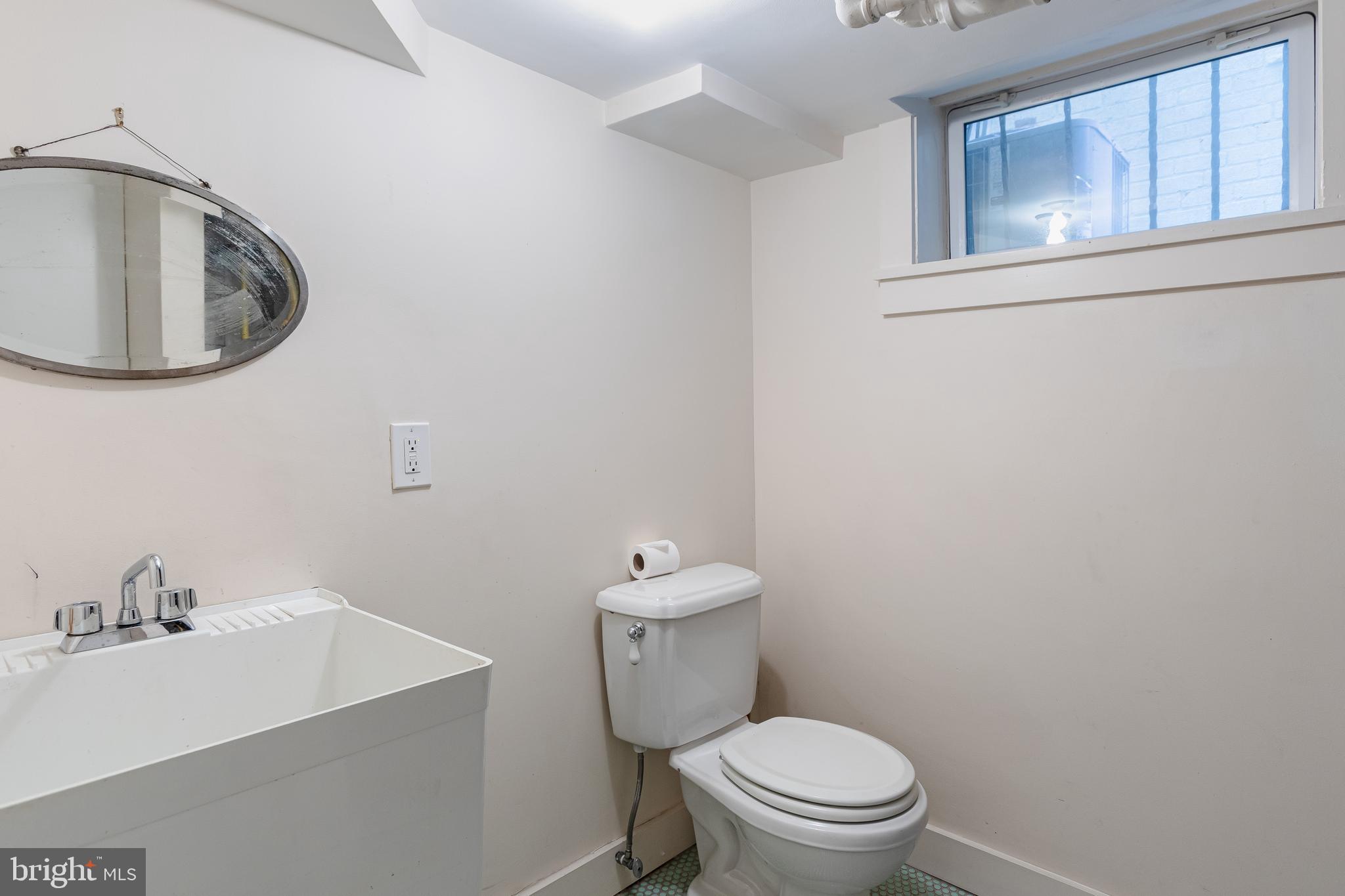 2633 15th Street Northwest, Unit 3 Washington, DC 20009 - Photo 48 of 53 a bathroom with a toilet sink and mirror