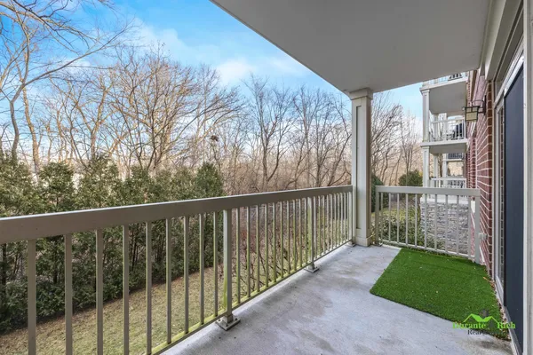 a balcony with trees in front of it