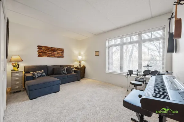 a bedroom with furniture and a large window