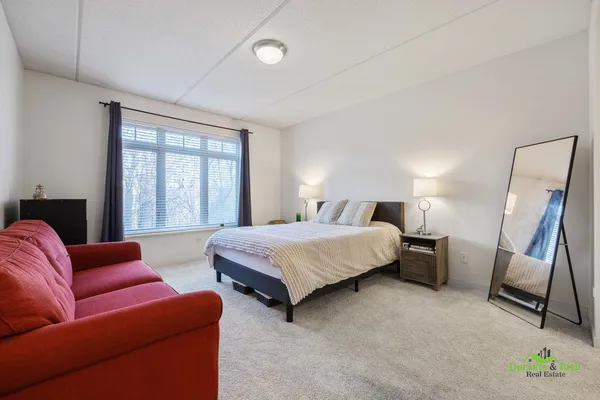 a bedroom with bed and wooden floor