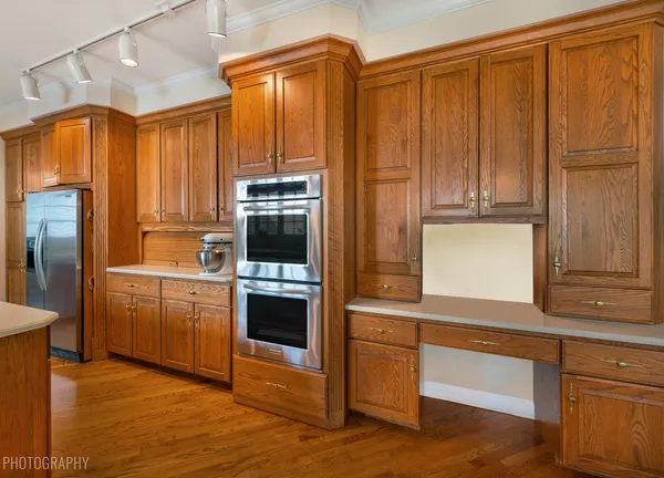 a kitchen with granite countertop wooden cabinets and stainless steel appliances