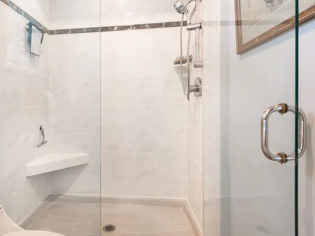 a bathroom with a shower and a shower