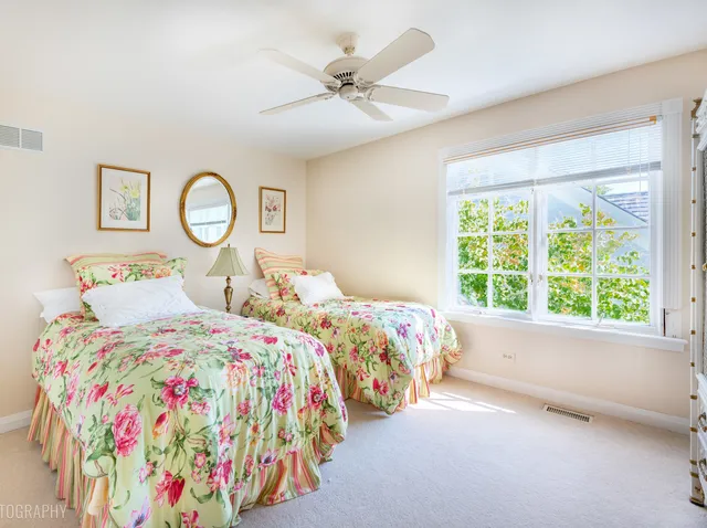 a bedroom with two beds and a window