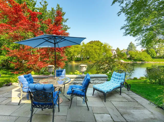 a view of an outdoor sitting area with furniture and umbrella