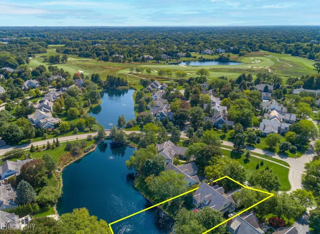an aerial view of residential houses with outdoor space and river