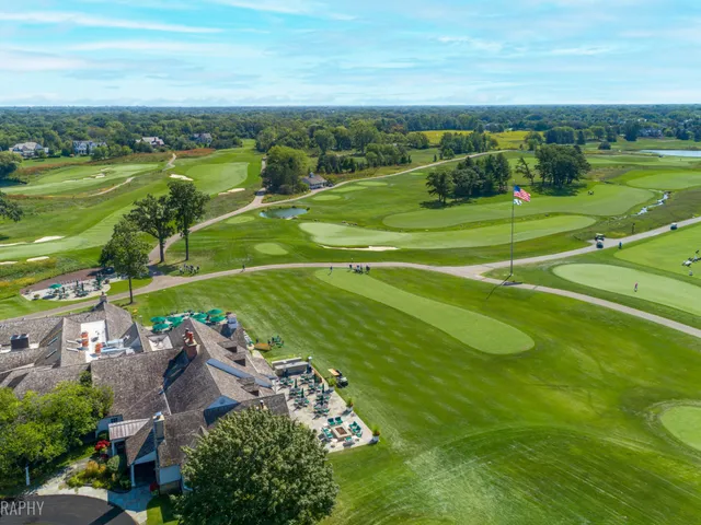 an aerial view of a golf course with a big yard