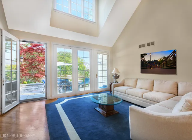 a living room with furniture and a floor to ceiling window