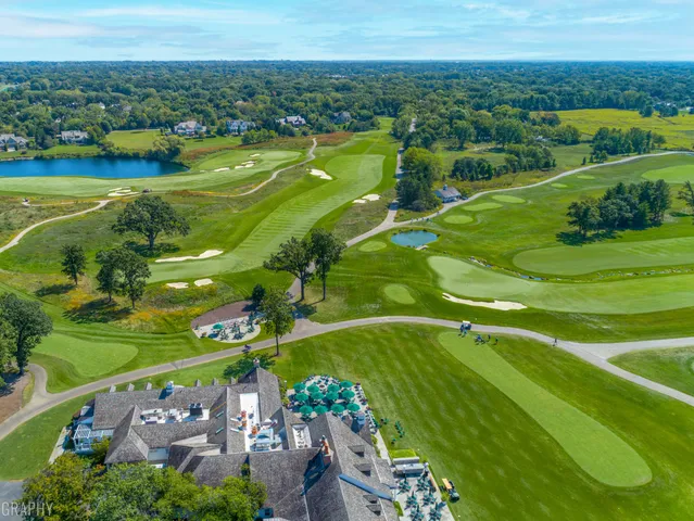 an aerial view of a houses with a yard