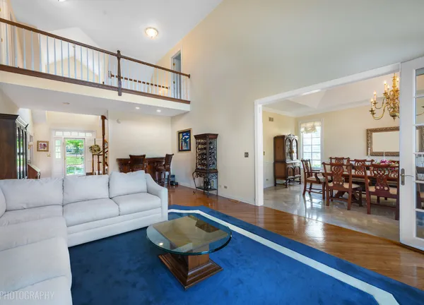 a living room with furniture and a view of kitchen