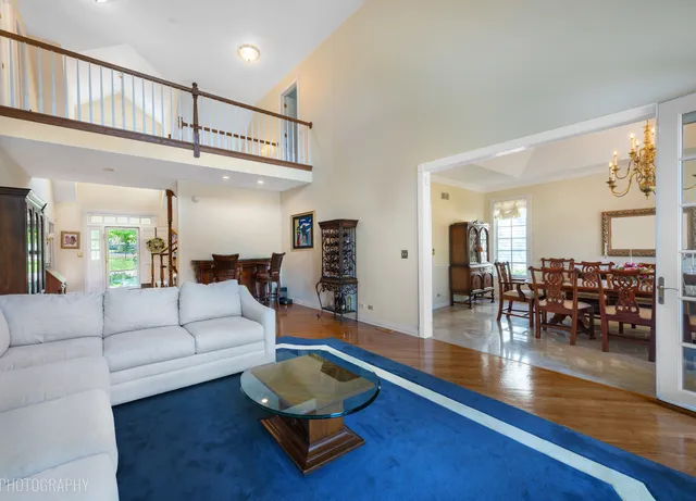 a living room with furniture and a view of kitchen