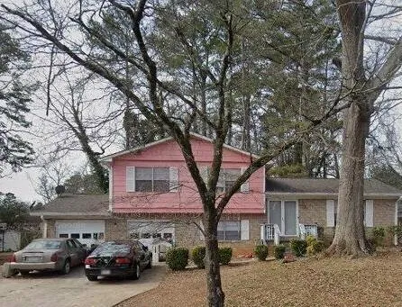 a view of a car parked in front of a house