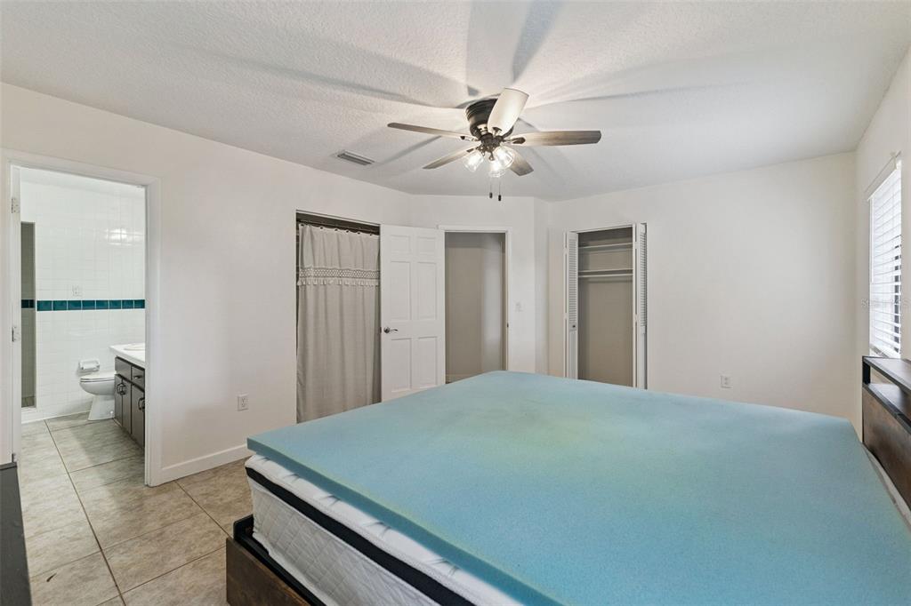 1142 Buckles Road Pierson, FL 32180 - Photo 15 of 34 a bedroom with a bed and a hallway