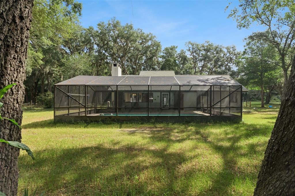 1142 Buckles Road Pierson, FL 32180 - Photo 23 of 34 a view of a house with swimming pool in a yard