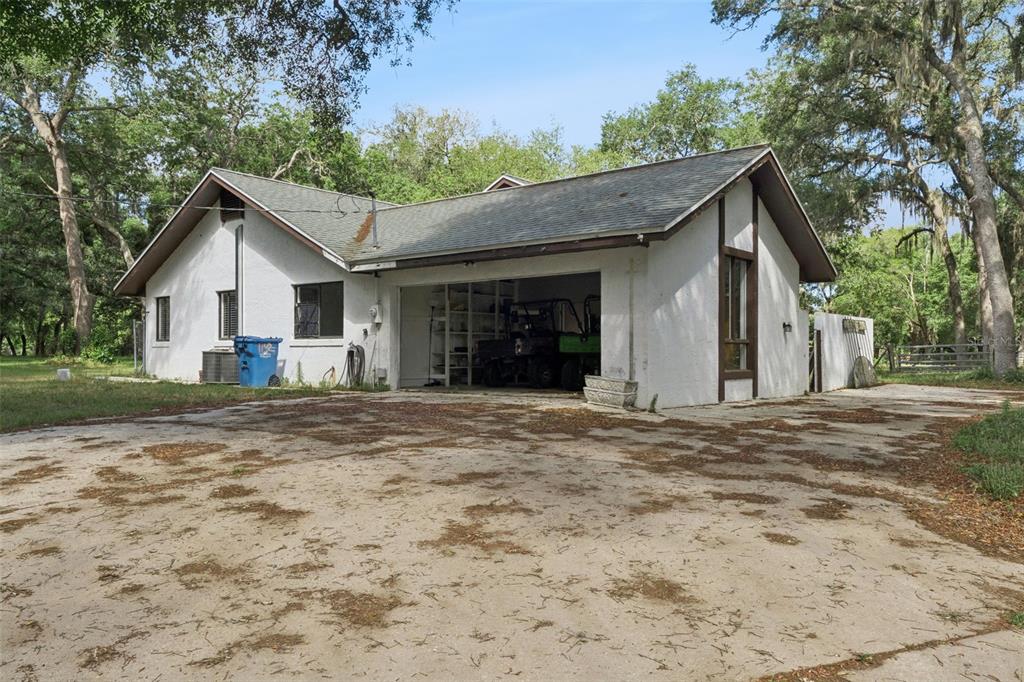 1142 Buckles Road Pierson, FL 32180 - Photo 24 of 34 a front view of a house with a yard and garage