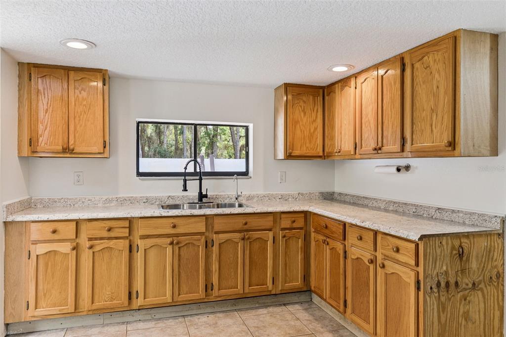 1142 Buckles Road Pierson, FL 32180 - Photo 10 of 34 a kitchen with a sink cabinets and window