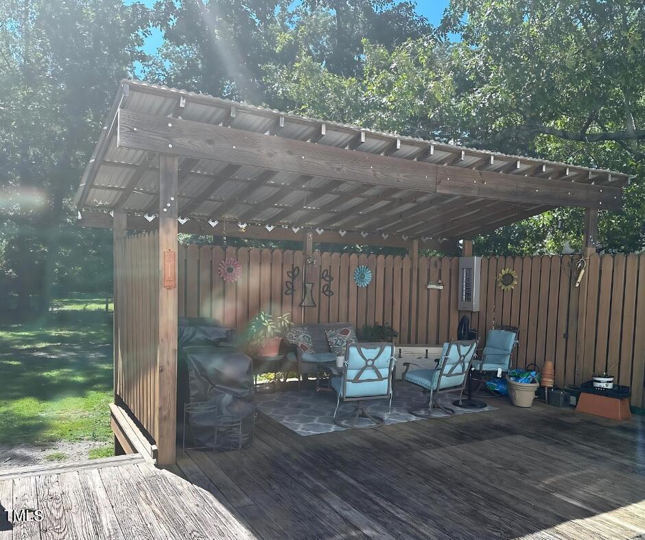 2937 Thrower Road Hope Mills, NC 28348 - Photo 17 of 20 a view of backyard with table and chairs and wooden fence