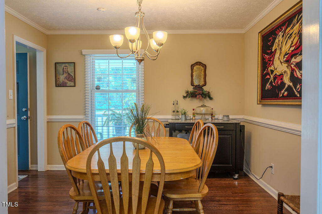 2937 Thrower Road Hope Mills, NC 28348 - Photo 9 of 20 a view of a dining room with furniture wooden floor and chandelier