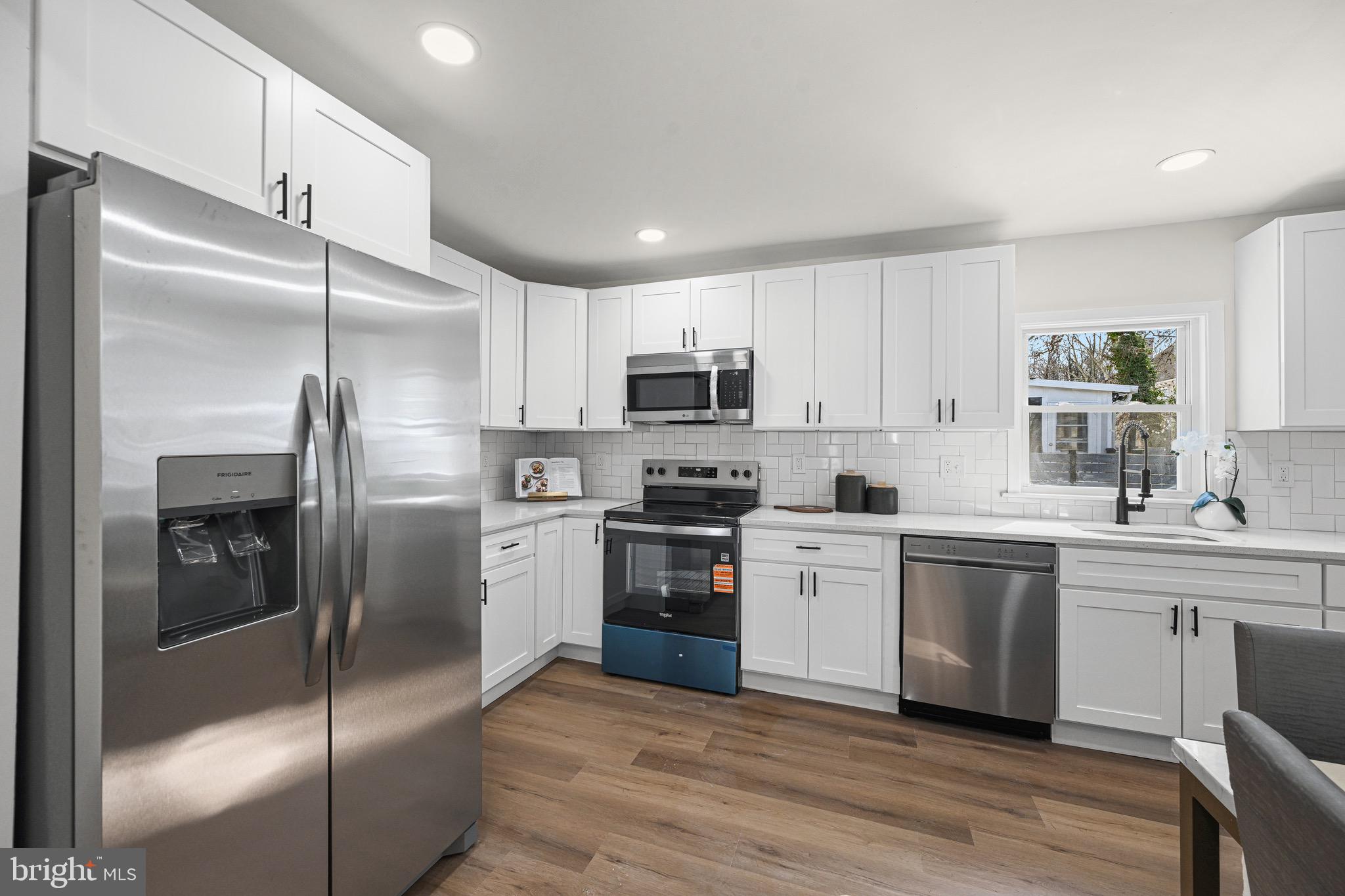 3718 4th Avenue Edgewater, MD 21037 - Photo 12 of 34 a kitchen with a refrigerator stove and microwave