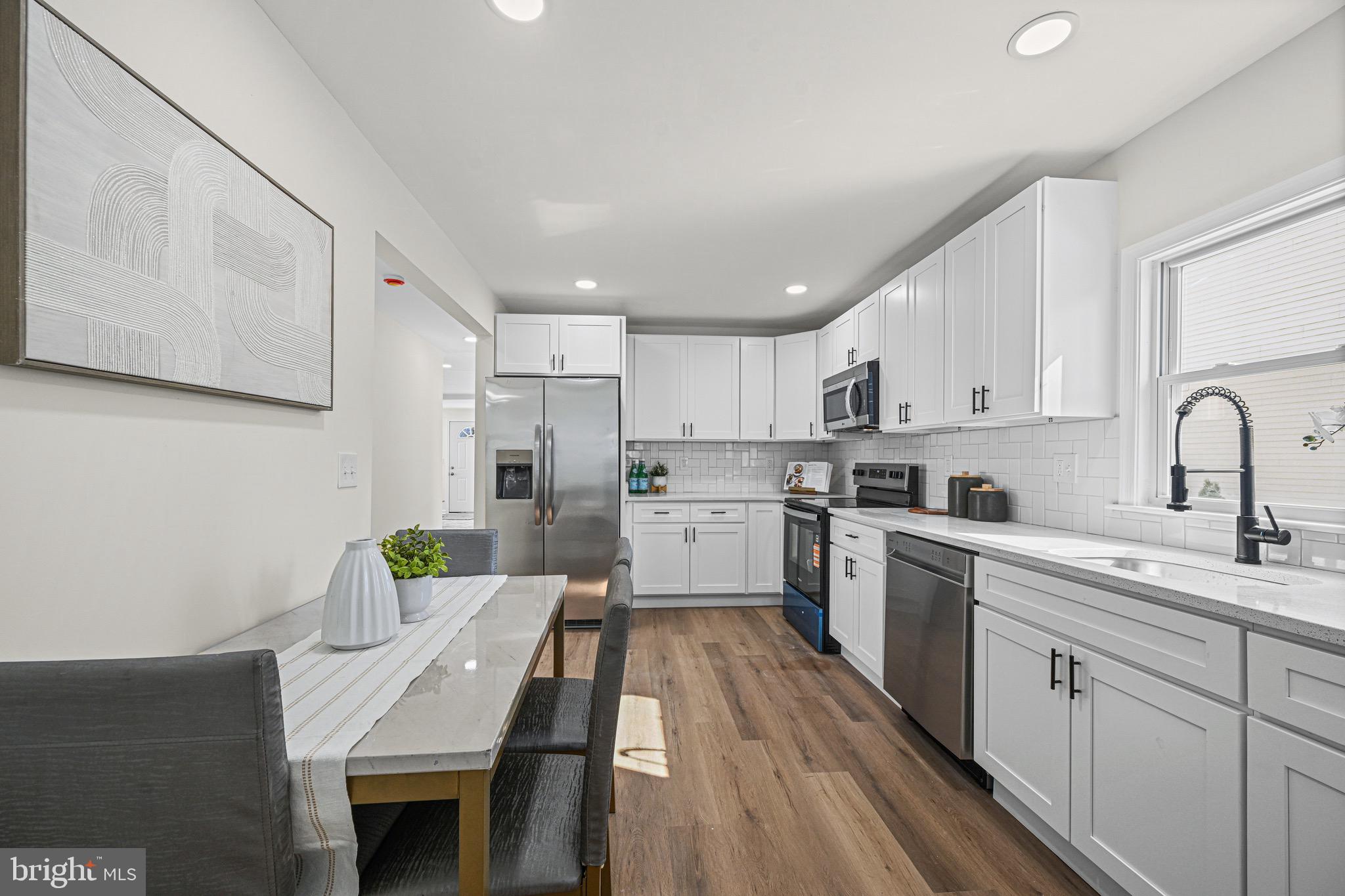 3718 4th Avenue Edgewater, MD 21037 - Photo 15 of 34 a kitchen with a sink a counter top space stainless steel appliances and cabinets