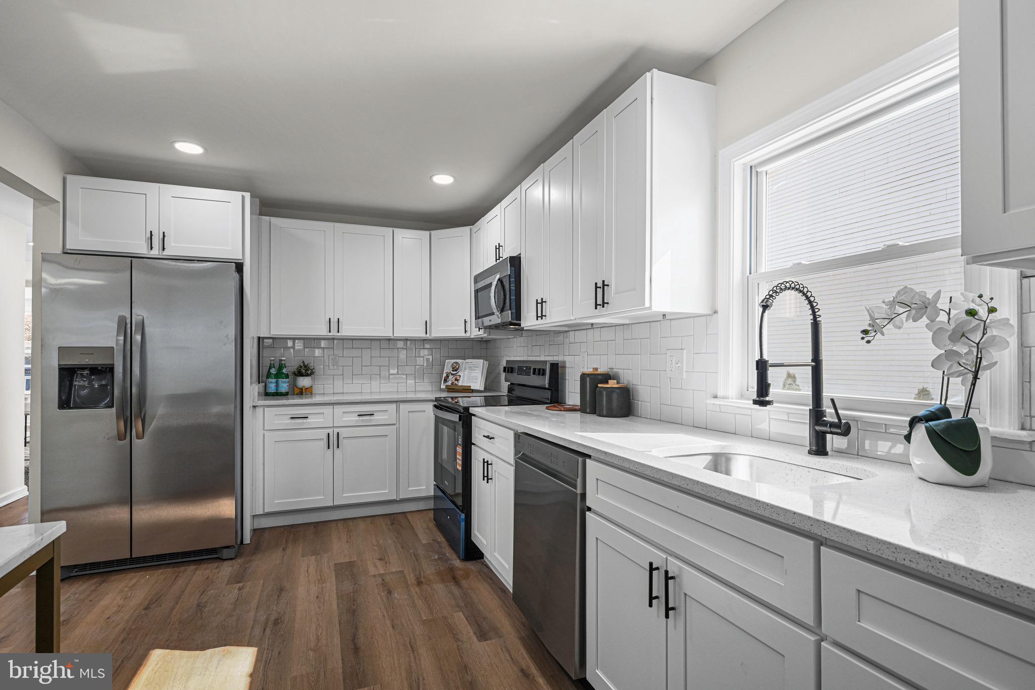 3718 4th Avenue Edgewater, MD 21037 - Photo 17 of 34 a kitchen with a sink stainless steel appliances and cabinets