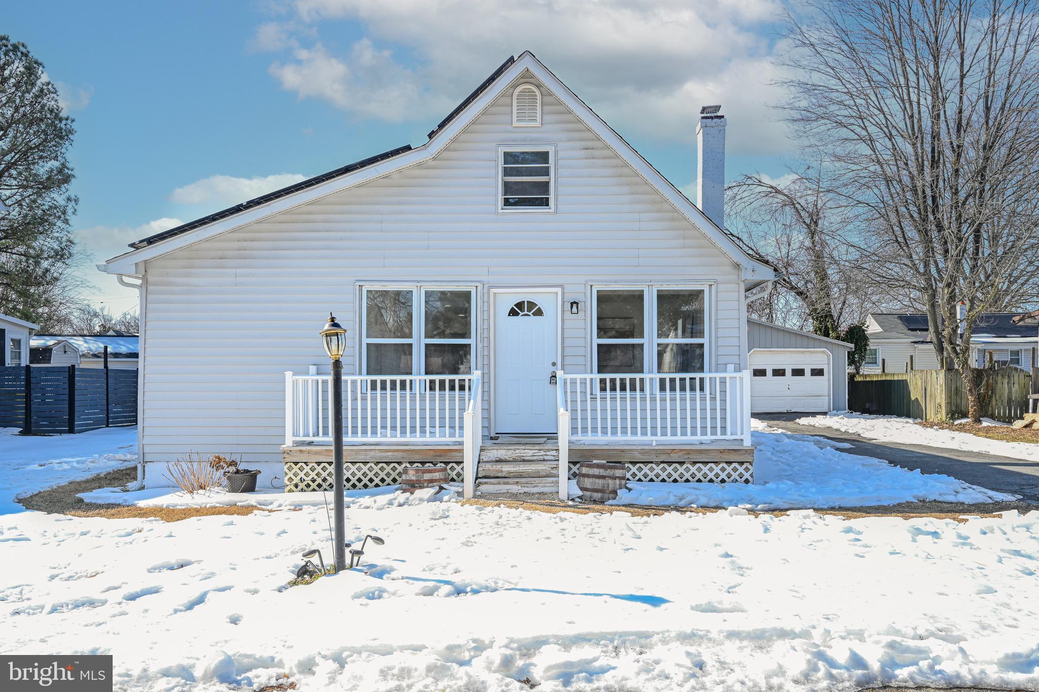 3718 4th Avenue Edgewater, MD 21037 - Photo 2 of 34 a front view of a house with a yard covered in snow