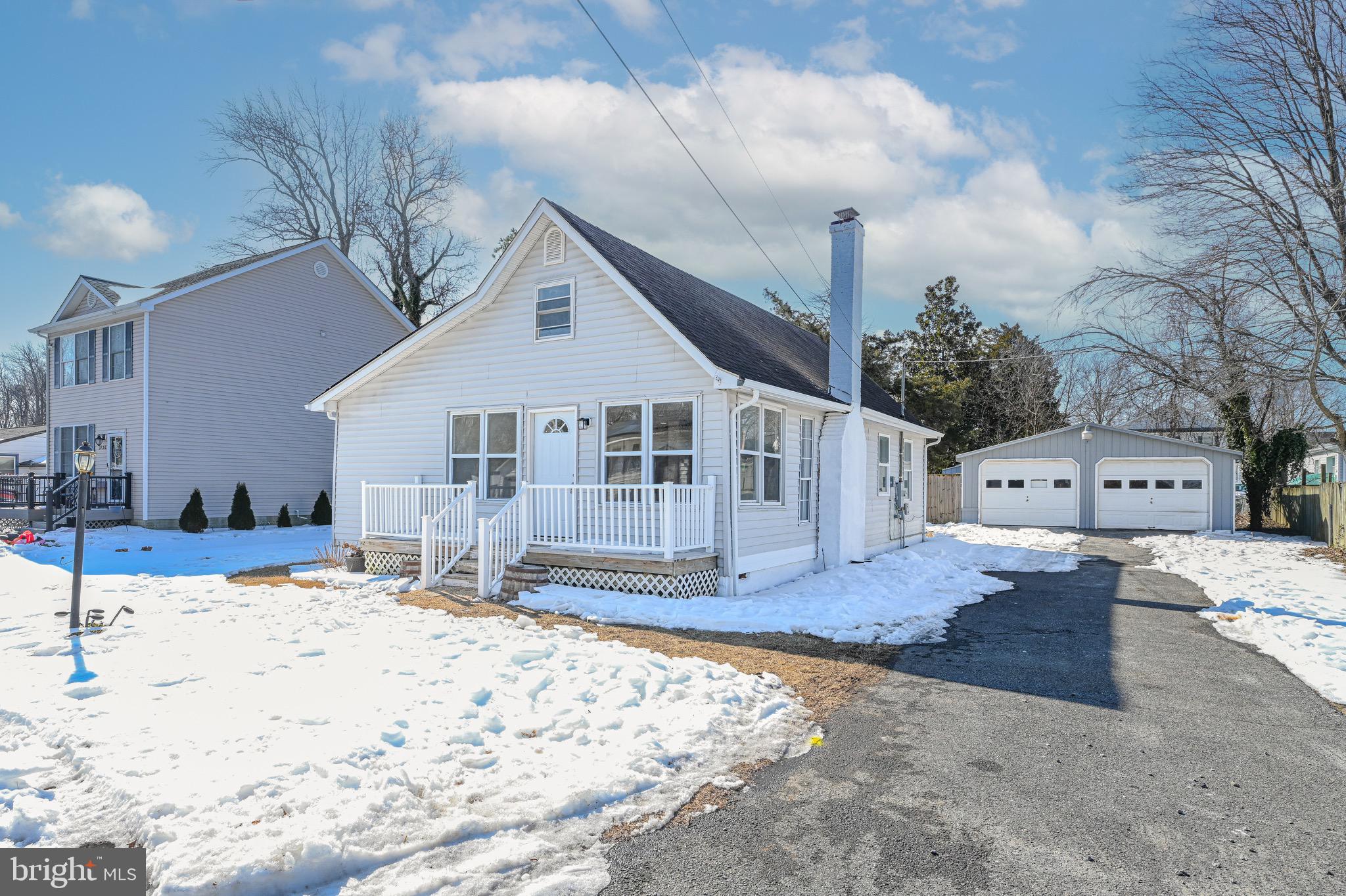 3718 4th Avenue Edgewater, MD 21037 - Photo 3 of 34 a front view of a house with a yard covered in snow