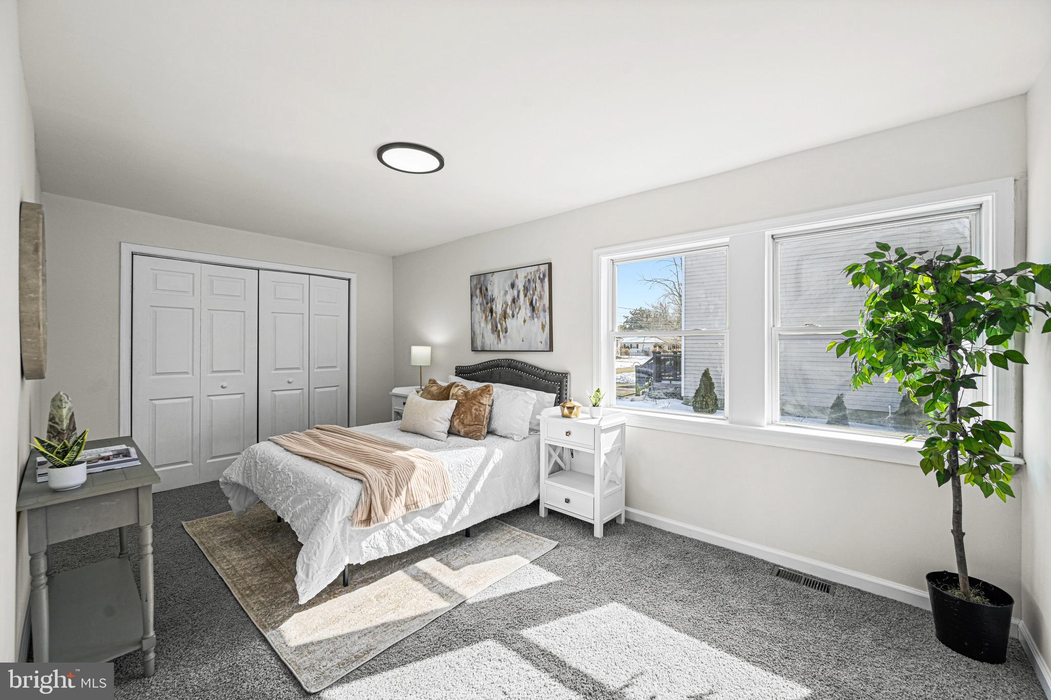 3718 4th Avenue Edgewater, MD 21037 - Photo 8 of 34 a bedroom with a bed and a potted plant