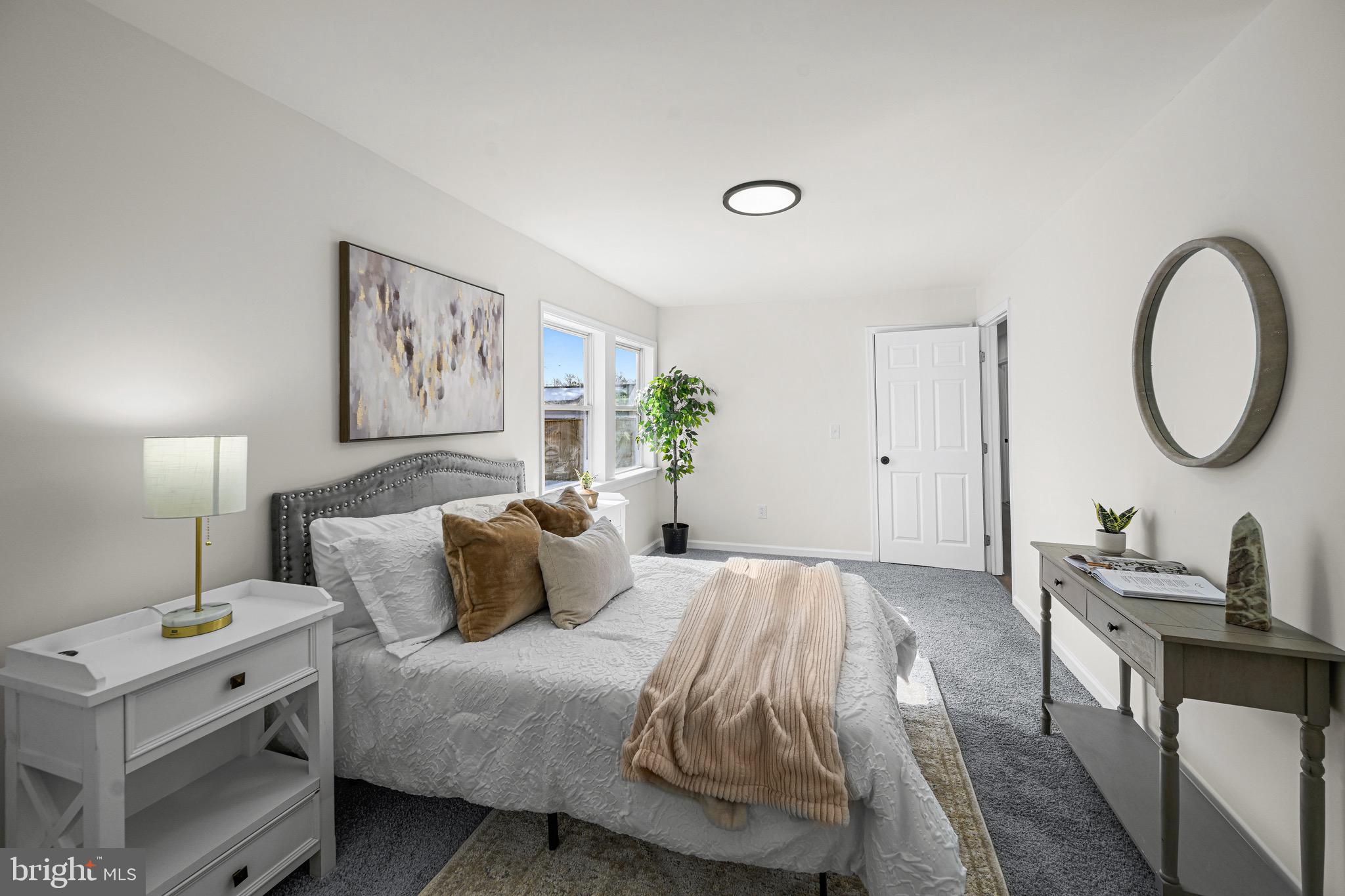3718 4th Avenue Edgewater, MD 21037 - Photo 9 of 34 a bedroom with a bed and a lamp on dresser