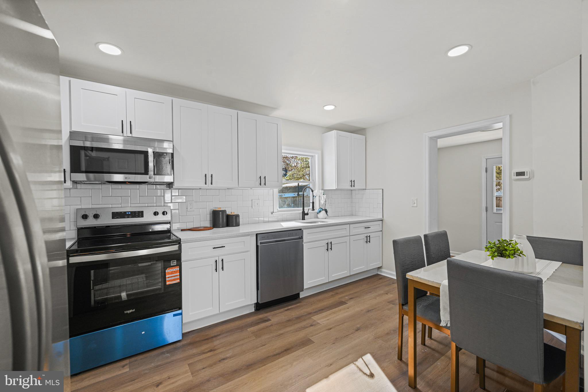 3718 4th Avenue Edgewater, MD 21037 - Photo 10 of 34 a kitchen with a sink white cabinets and stainless steel appliances