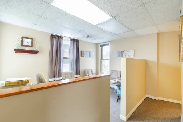 a view of a kitchen with refrigerator and windows