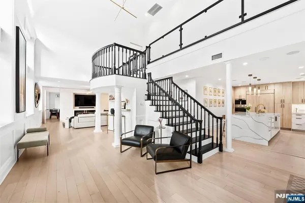 a view of entryway livingroom and hall with wooden floor