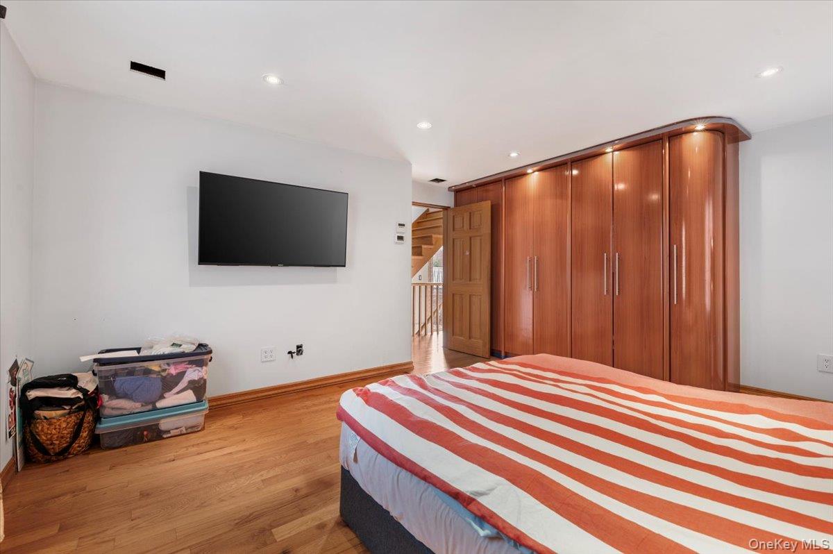 82-06 166th Street Queens, NY 11432 - Photo 13 of 25 Bedroom featuring light wood finished floors, recessed lighting, and a closet