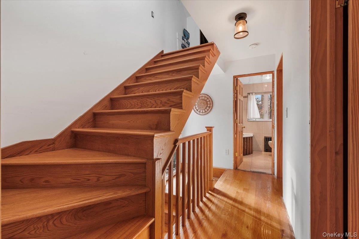 82-06 166th Street Queens, NY 11432 - Photo 16 of 25 Stairs featuring wood finished floors