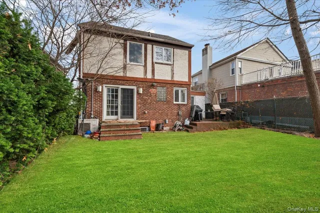 a view of a house with a yard and sitting area