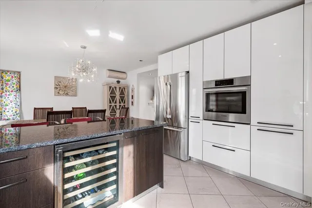 a kitchen with kitchen island a counter top space appliances and cabinets
