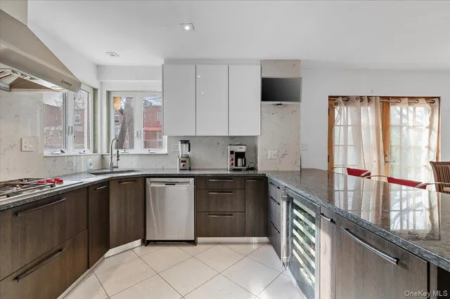 a kitchen with stainless steel appliances a sink stove and cabinets
