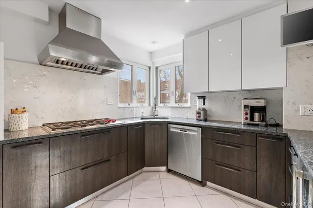 a kitchen with a sink and a stove top oven