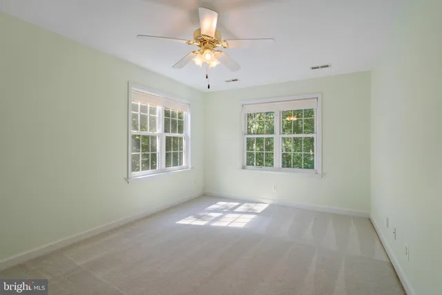 an empty room with a stove and a refrigerator