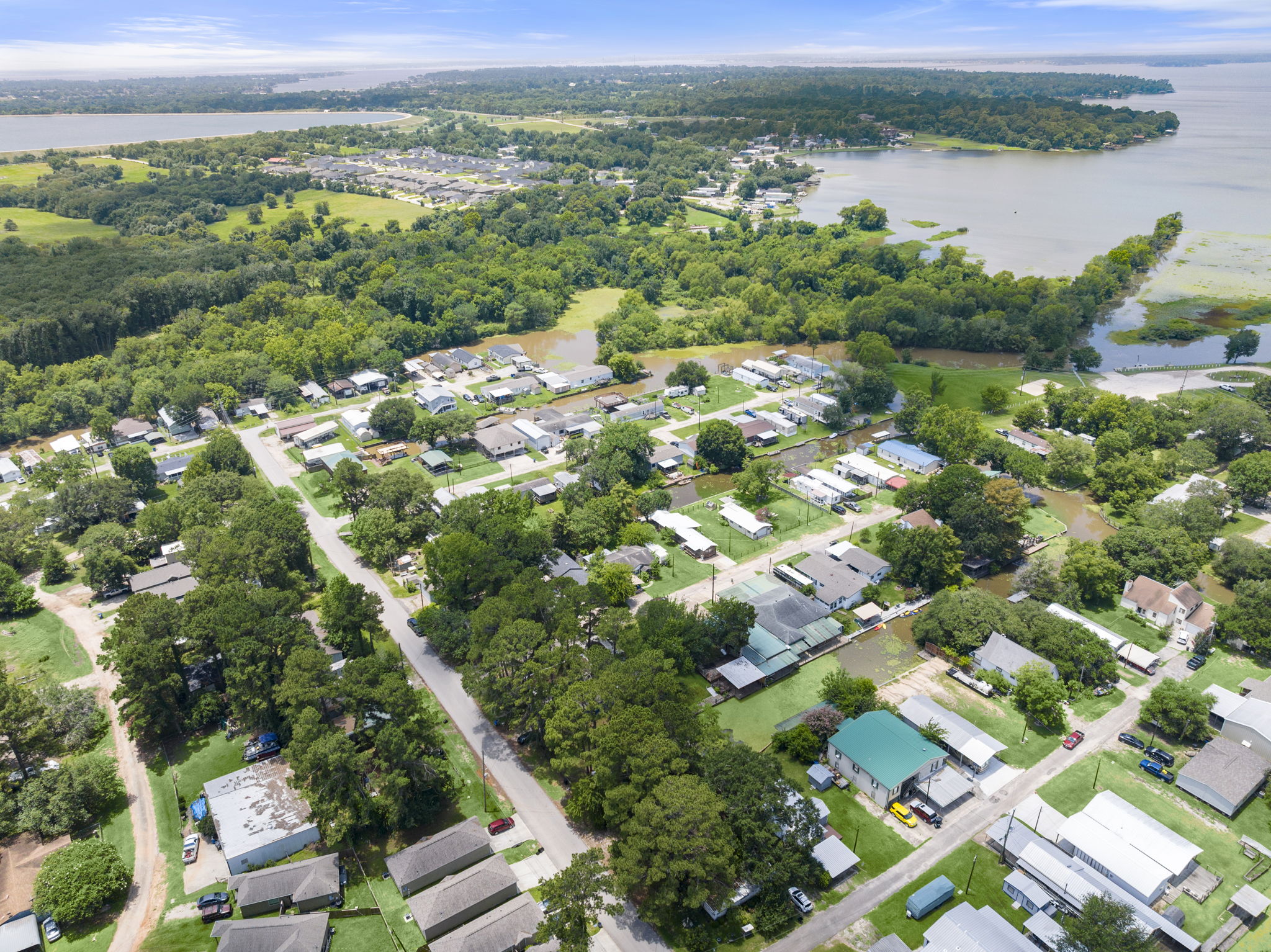 9649 Warm Spring Willis, TX 77318 - Photo 28 of 30 Aerial view showcasing a tranquil waterfront community, nestled amidst lush greenery.