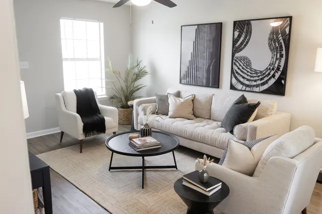 a living room with furniture and a large window