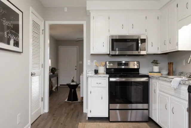a kitchen with stainless steel appliances granite countertop a stove and a refrigerator