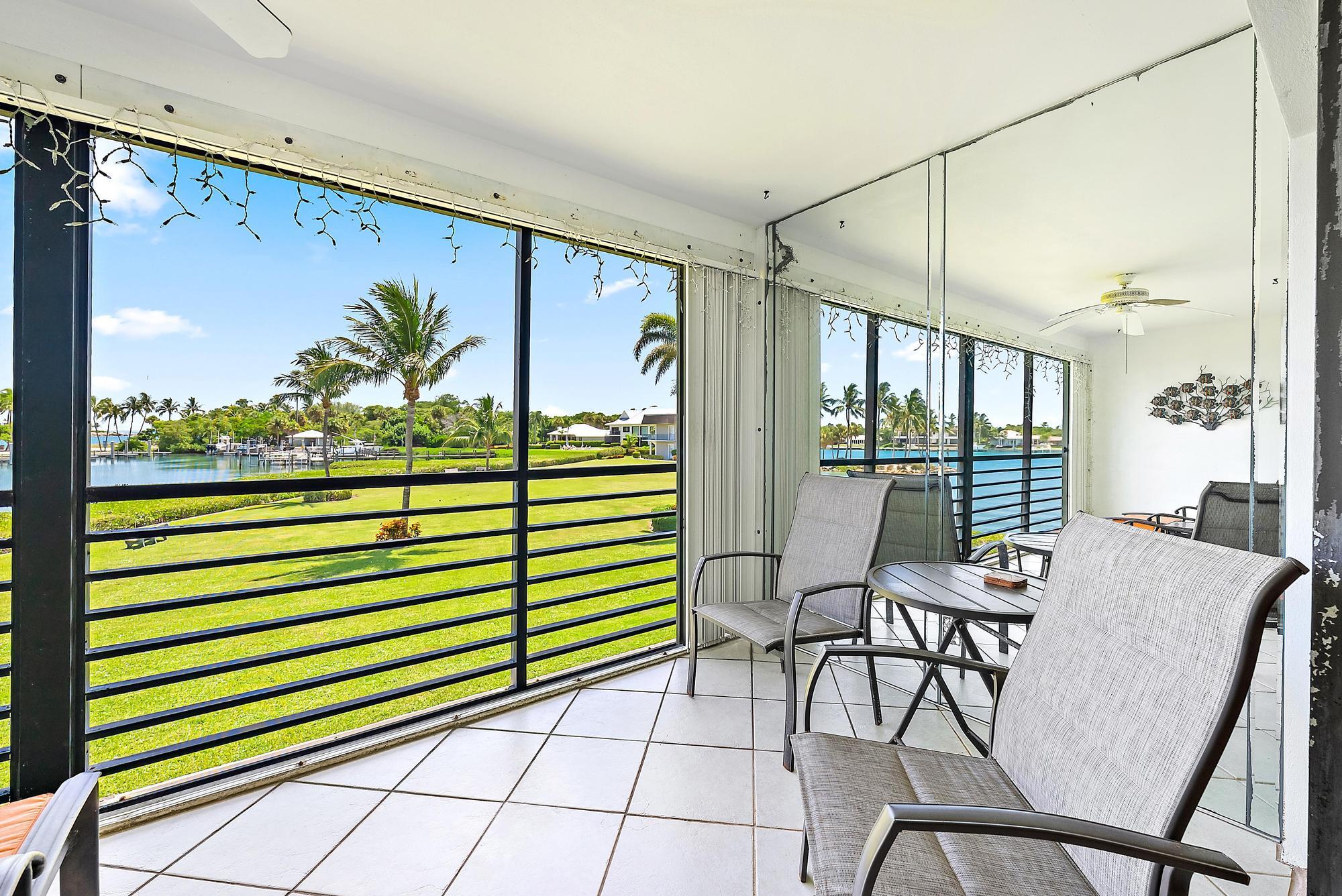 755 Saturn Street, Unit D205 Jupiter, FL 33477 - Photo 14 of 22 a view of a dining room with furniture window and outside view