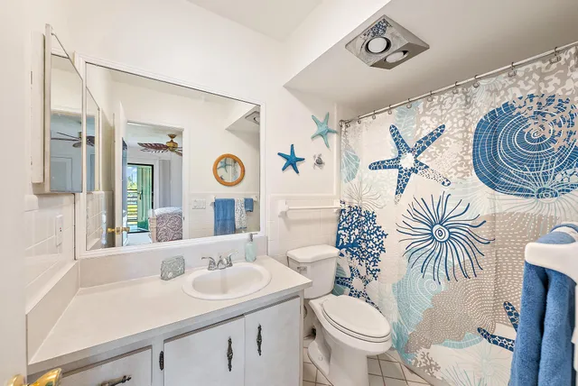 a bathroom with a toilet a sink and a mirror