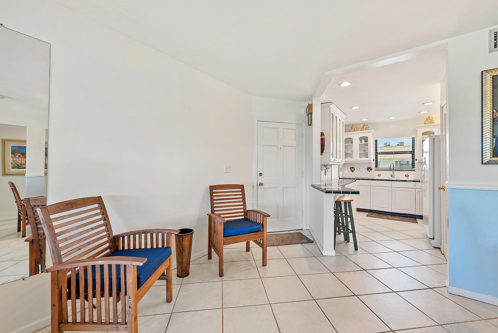755 Saturn Street, Unit D205 Jupiter, FL 33477 - Photo 5 of 22 a view of kitchen with furniture and a rug