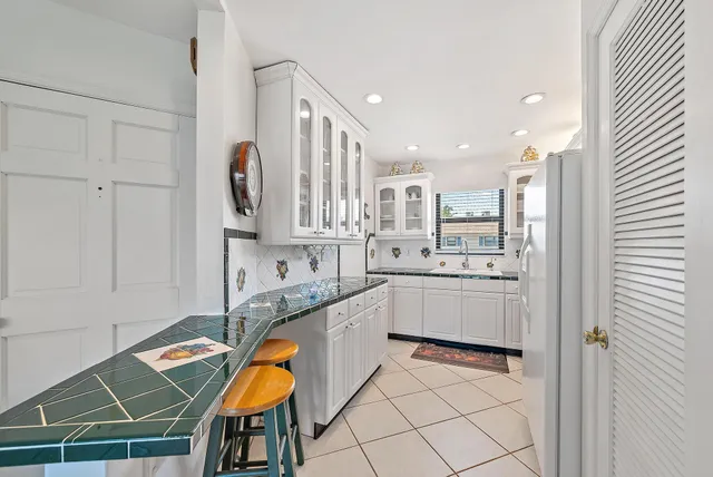 a kitchen with stainless steel appliances granite countertop a sink and cabinets