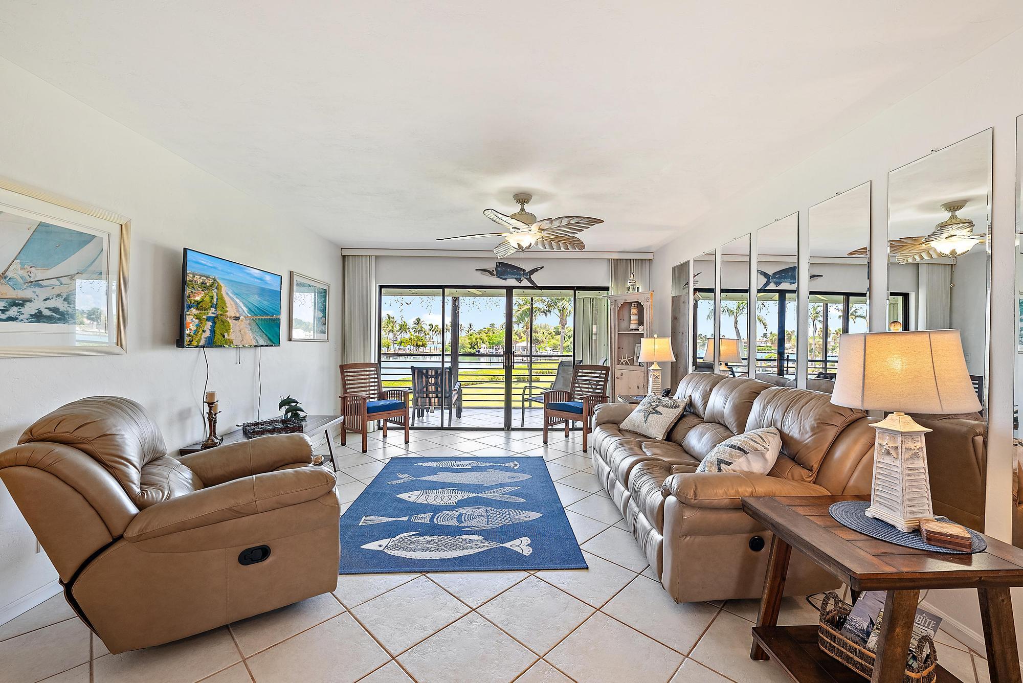 755 Saturn Street, Unit D205 Jupiter, FL 33477 - Photo 10 of 22 a living room with furniture and a large window